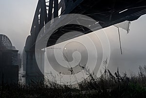 Iron bridge over the Po surrounded by fog. Cremona.