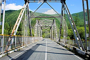 Iron bridge over the river. Siberia.