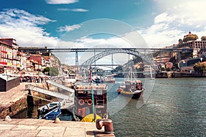 The iron bridge Ponte Dom LuÃ­s I over the river Douro with boats in Porto