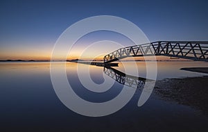 Iron bridge and wooden walkway over the Mar Menor, Cartagena, Spain, at sunrise