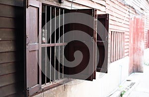 Iron cage windows in ancient wooden buildings At Soi Naklua Factory, Pattaya, Thailand