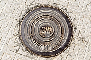 Iron canal cover between the concrete pavement