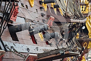 Iron cannon on sail ship