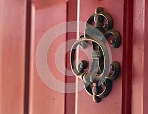 Iron cast door knocker on red door