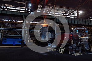 Iron casting and the foundry. Overhead crane with ladle with molten metal at metallurgical factory