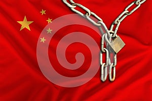 Iron chain and castle on the silk national flag of China with beautiful folds, the concept of a ban on tourism, political