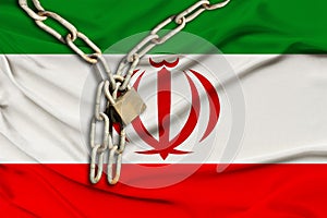 Iron chain and castle on the silk national flag of iran with beautiful folds, the concept of a ban on tourism, political