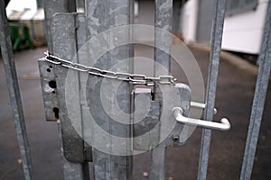 Iron chain on the door, securely locked, entry is strictly prohibited, concept prison, security zone, symbol of bondage,