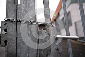 Iron chain on the door, securely locked, entry is strictly prohibited, concept prison, security zone, symbol of bondage,