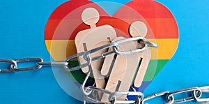 Iron chain figures of people on LGBT rainbow flag