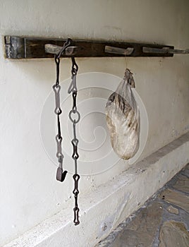 Iron chain with a hook and a wineskin in the basement of a traditional Bulgarian village house, Silistra Province, the South Dobru