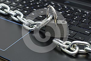 an iron chain, an open padlock on a computer keyboard the concept of data protection censorship on the Internet