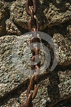 Iron chain stuck in a stone brick wall