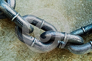 Iron chains on concrete background. Close-up, outdoor