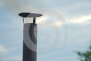 Iron chimney, chimney and smoke against the sky