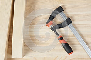 Iron clamps. Clamps and vices. Wooden bars on workshop table photo