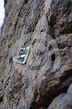 Iron climbing hook bolted to a granite rock