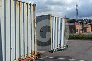 Iron containers to transport goods against a dark sky