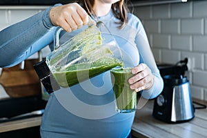 Iron deficiency, anemia, iron boosting smoothie recipes for pregnant woman. Pregnant woman preparing green vitamin