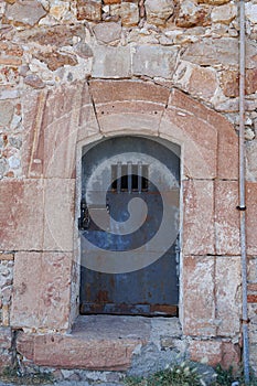 Iron Door of a Dungeon with Grates in Montjuic Castle in Barcelona, Spain