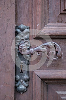 Iron door handle of an old door of a historical building