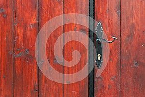 Iron door handle on old wooden door close up outdoor shot