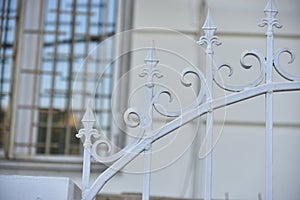 Iron fence with pins and lanterns in the city