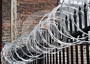 Iron fence with razor and barbed wire