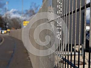 Iron fences turns along the road into the horizon