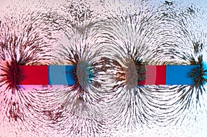 Iron filings on the magnetic field on a magnet photo