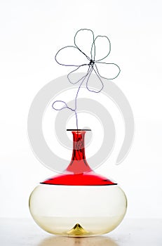 Iron flower in red jar minimal stll life composition