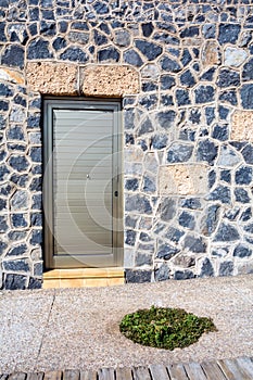 Iron front door. Stone house