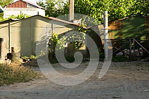 Iron garages in a garage cooperative with branches of grapes