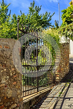 Iron gate to the garden in a wall