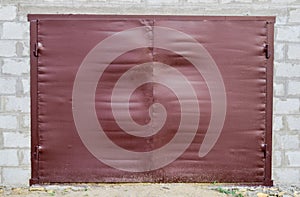 Iron gates on the garage. Brown gates made