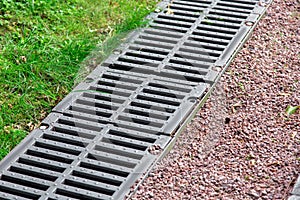 Iron grate of a drainage channel on a landscape. photo