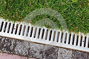 Iron grate of a storm drainage system on the side.