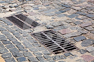 The 2 iron grates of the drainage system hatch. photo