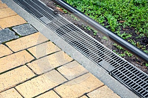 Iron grating of the drainage system for drainage of rainwater in the backyard.