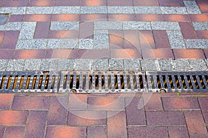 Iron grating line of the drainage system of the pedestrian sidewalk.