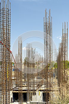 Iron grid for reinforcement of a building walls and foundation and concrete blocks at construction site.