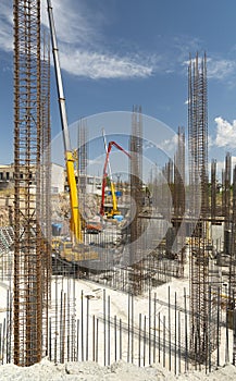 Iron grid for reinforcement of a building walls and foundation and concrete blocks at construction site.