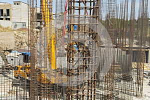 Iron grid for reinforcement of a building walls and foundation and concrete blocks at construction site.