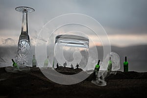 Iron handcuffs for the arrest of criminals, a glass of vodka on a wooden. background. a crime committed while intoxicated