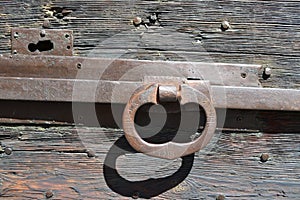 Iron handle of the lock of an ancient wooden door