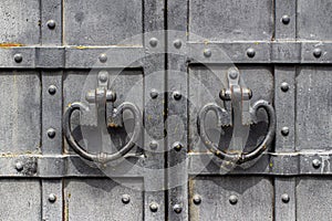 Iron handles on the metal-bound door