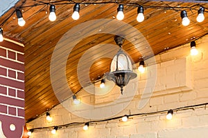 Iron hanging on the ceiling retro lantern with a light bulb.