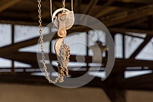 An iron hook on a pulley and a chain