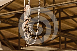 An iron hook on a pulley and a chain