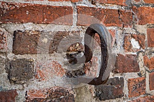 Iron hooks in a brick wall